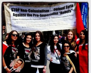 Sydney, August 5:  Syrian origin youth pose for a photo in front of the Trotskyist Platform banner at the thousands strong, Hands Off Syria rally.
