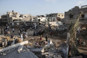 Palestinians inspect damage in the Gaza town of Khuza’a. Israel’s 2014 assault killed over 2,000 Palestinian civilians and devastated Gaza.