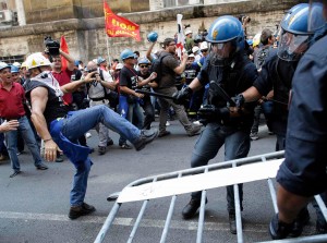 Rome, Italy, September 2012: Workers from aluminium maker Alcoa’s Sardinia factory try to break police lines to storm the Industry Ministry in an attempt to defeat threatened job losses.