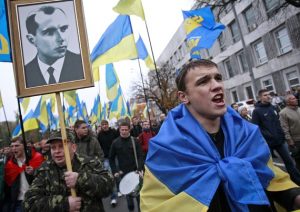 October2013: Supporters of the Ukrainian fascist Svoboda party with a portrait of Stepan Bandera. Bandera was the bloodthirsty leader of anti-Soviet, Nazi-collaborating Ukrainian fascists during World War II.