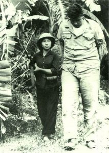 1966: A Vietnamese communist woman fighter marches a captured American airman through the jungle during the Vietnam war.